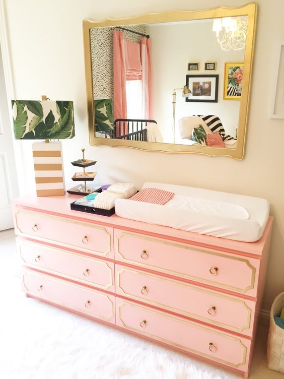 IKEA Malm dresser with coral paint, trim and ring pulls as a stylish mid century modern changing table