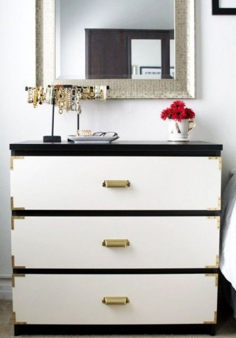 a black IKEA Malm dresser with white drawers, metallic corners and vintage metal handles for a touch of classic glam