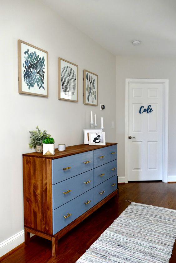 A bold Tarva hack with rich colored stain and blue paint, with brass handles for a mid century modern space