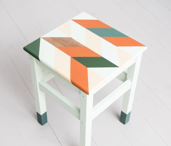 A bright IKEA Oddvar hack with dipped legs and a bright stenciled seat for a mid century modern touch
