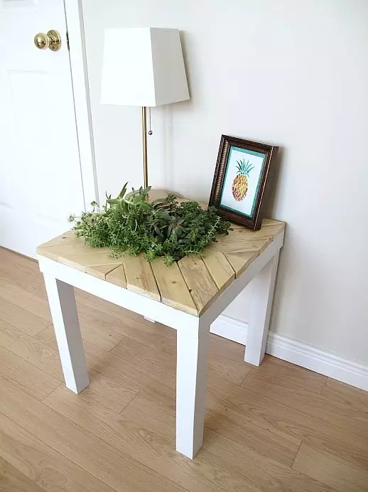 A chic farmhouse Lack table hack with light colored wood and a planter right in the center