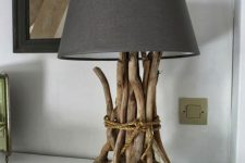 a cool and simple table lamp with a base covered with driftwood and a black lampshade is a lovely idea for a modern interior