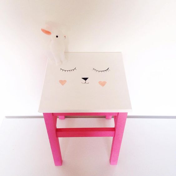 a cute IKEA Oddvar stool hacked with bright pink paint and a cute bunny face on top for a kids' room