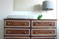 a dark stained IKEA Tarva dresser with white inlays and bright yellow knobs is a stylish dressing table