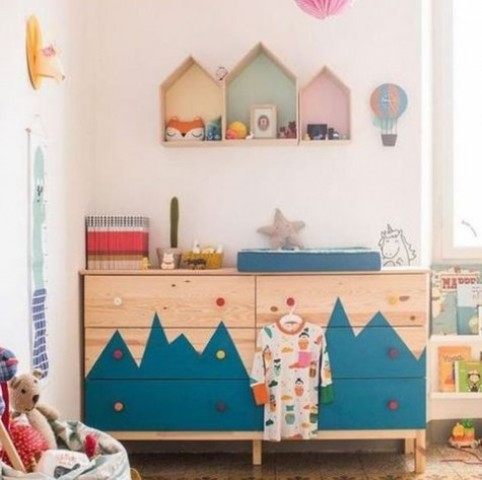 A double Tarva dresser with a mountain inspired pattern and colorful knobs for an adventure themed kid's room
