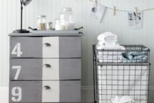a grey IKEA Tarva hack with a white stripe, numbers, vintage knobs and casters for an industrial space