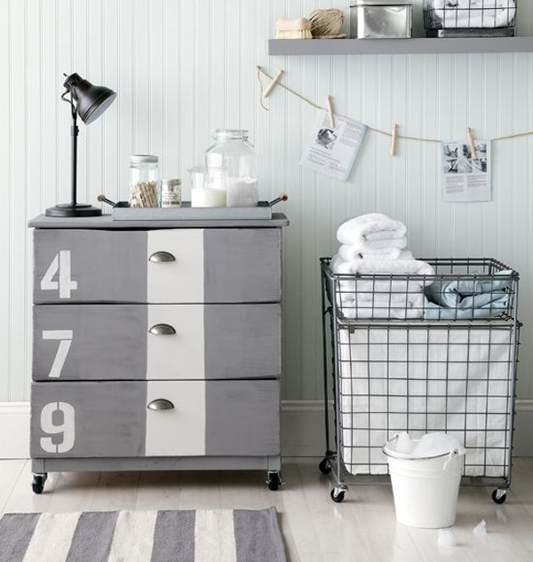 a grey IKEA Tarva hack with a white stripe, numbers, vintage knobs and casters for an industrial space