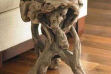 a little and cool driftwood side table made of a single piece of driftwood is a lovely way to reuse some driftwood making it a statement decor piece