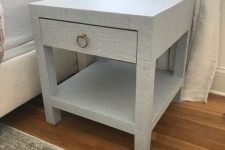 a lovely IKEA Lack table hack into a nightstand with an additional shelf, a drawer covered with grasscloth wallpaper is chic