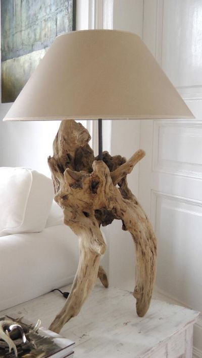 a lovely driftwood table lamp of a cool piece of driftwood and a neutral lampshade is a stylish solution to go for