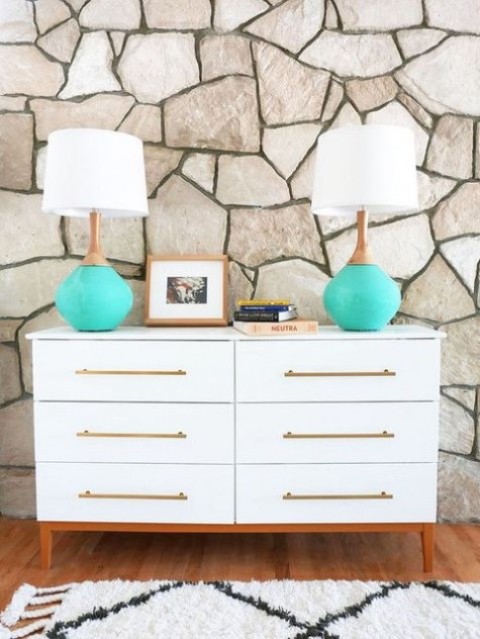 A mid century modern Tarva hack with long brass handles and colored legs is elegant and chic