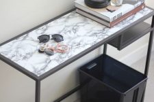 a modern entryway console table of an IKEA Vittsjo desk with a marble adhesive paper top is a stylish idea for a Scandi space