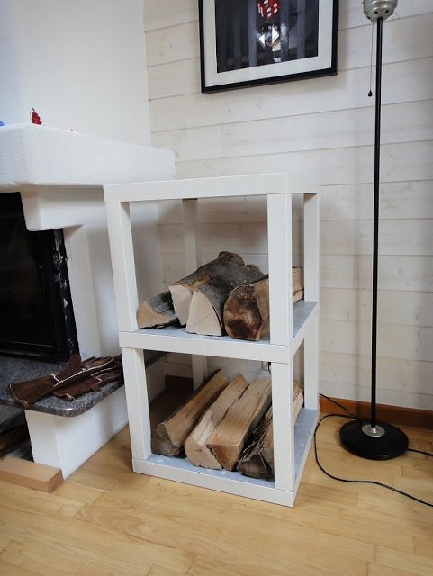 A simple and pretty IKEA Lack table hack   two pieces used to build a single firewood stand by the fireplace, which is a smart solution