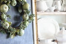a simple fall wreath of green apples, berries, leaves and a plaid ribbon is farmhouse-like and easy to DIY