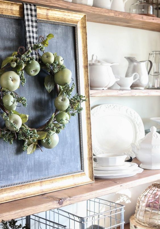 a simple fall wreath of green apples, berries, leaves and a plaid ribbon is farmhouse-like and easy to DIY