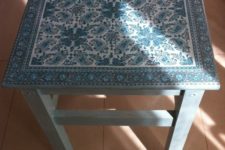 a slate blue IKEA Oddvar stool with a beautiful decoupage seat can be used as a side table or a chair