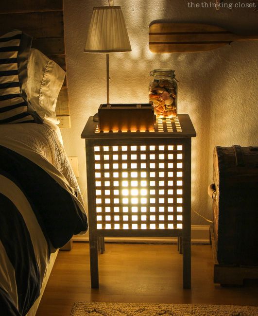 a small nightstand with a lamp inside is a romantic night light that will create a mood in the space