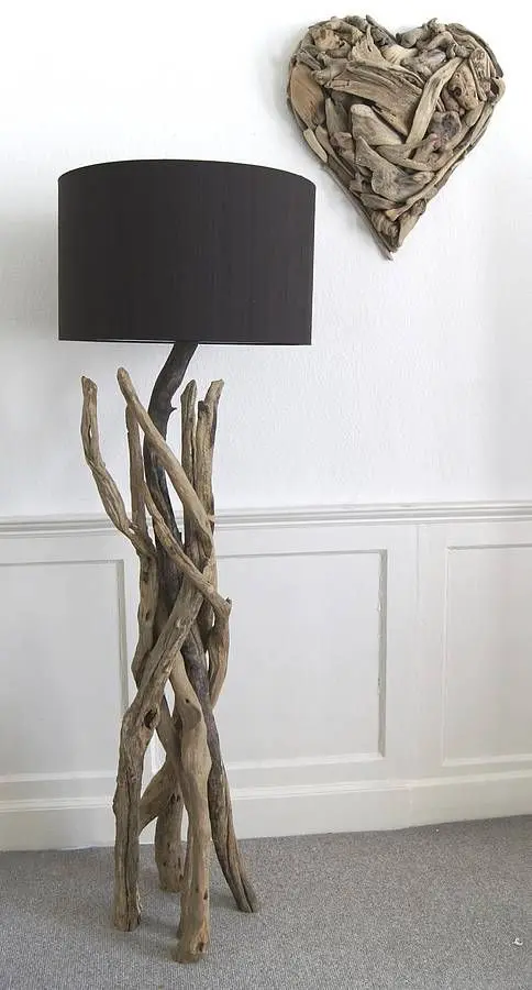 a stylish floor lamp of driftwood, with a black lampshade is a beautiful way to reuse driftwood and add a natural feel to the interior