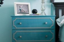 a turquoise IKEA Tarva dresser hack into a nightstand, with white inlays and silver knobs