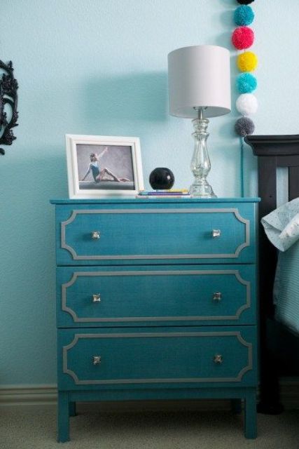 a turquoise IKEA Tarva dresser hack into a nightstand, with white inlays and silver knobs