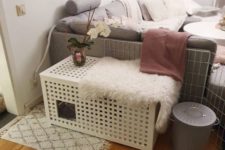 a white IKEA Hol side table with a pet retreat inside and a faux fur cover is a double-function item