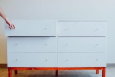a white Tarva dresser hack with tiny knobs and a red frame and legs for a contemporary space