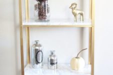 an IKEA Hyllis hack with gold spray paint and marble contact paper is a veyr glam and chic idea
