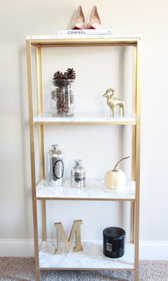 an IKEA Hyllis hack with gold spray paint and marble contact paper is a veyr glam and chic idea