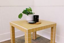 an IKEA Lack table covered with yellow tiles all over is a stylish and bold accent in the interior that can withstand any conditions