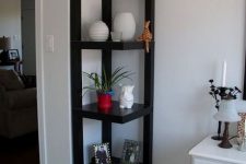 several black IKEA Lack tables designed into a single corner etagere will help you display and accommodate a lot of stuff