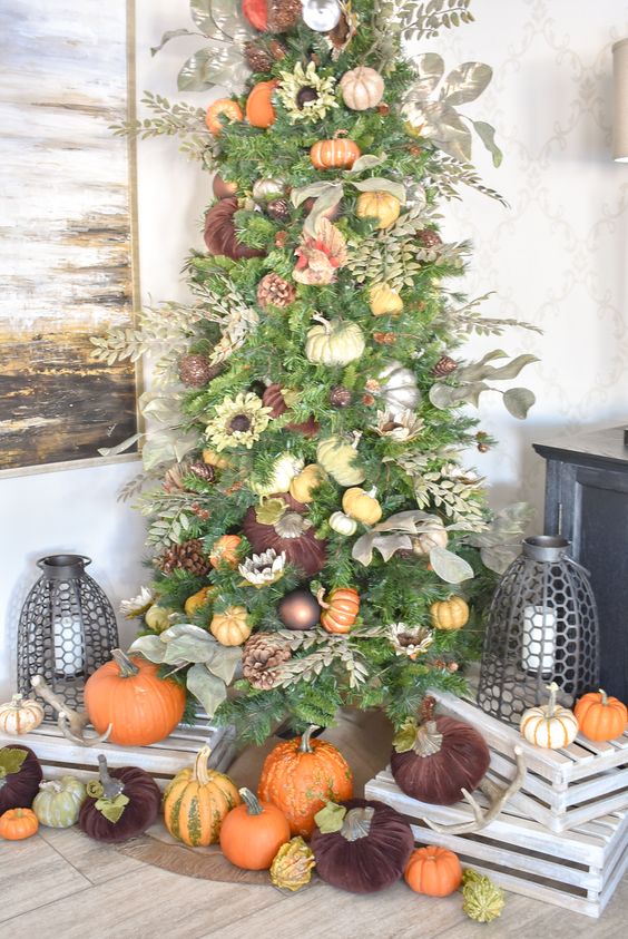 a Thanksgiving tree decorated with ornaments, faux pumpkins, pinecones, faux leaves and foliage is a chic idea