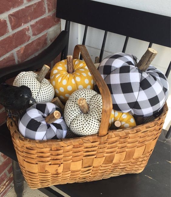 a basket with faux pumpkins of plaid and polka dot fabric are stylish for fall or Halloween