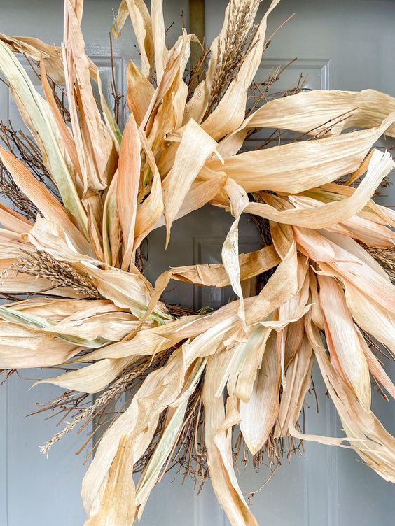 A beautiful and all natural corwn husk and wheat wreath is a great idea for fall outdoor decor and looks lovely