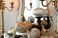 a beautiful fall arrangement of fabric and metallic pumpkins, blooms and pinecones for a refined vintage-inspired space