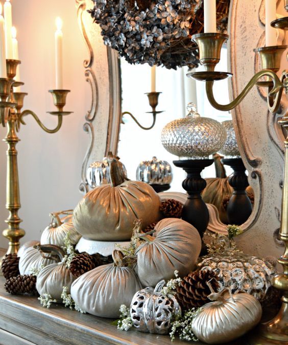 A beautiful fall arrangement of fabric and metallic pumpkins, blooms and pinecones for a refined vintage inspired space