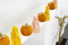 a bright and fun fall garland of yarn pumpkins and tassels is a lovely idea for fall and Thanksgiving
