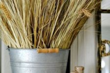 a bucket with wheat is a cool rustic decoration for the fall, it’s veyr easy to compose