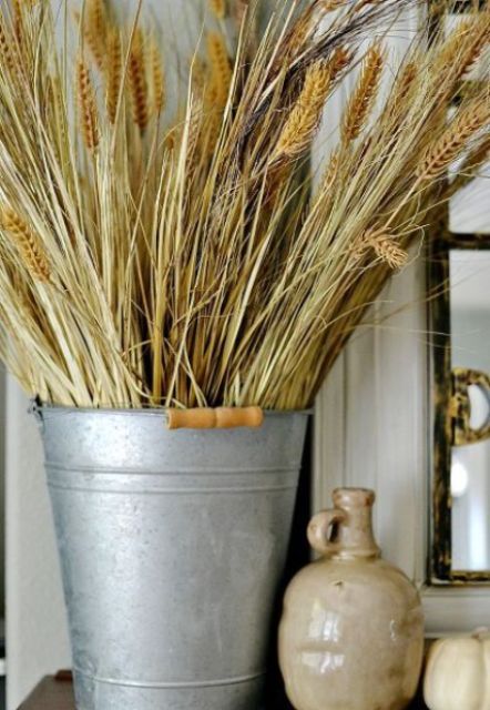 a bucket with wheat is a cool rustic decoration for the fall, it's veyr easy to compose