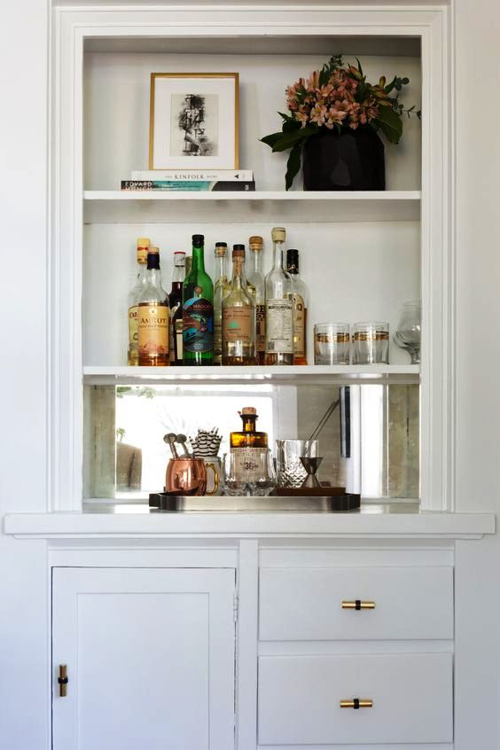 a built-in bar with some open shelves and closed storage compartments is a cool space-saving idea
