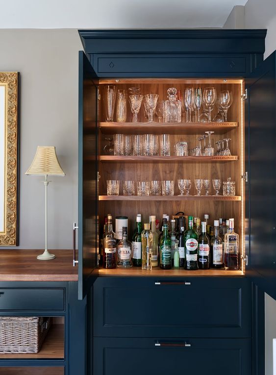 A built in home bar with open shelves with lights and drawers for storage is a very cool idea to rock