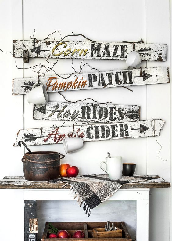 a bunch of white and black fall signs with mugs hanging on them look very relaxed and farmhouse-like