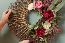 a chic fall wreath of twigs and sticks, greenery and blooms is a beautiful decoration to DIY