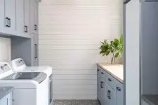 a lovely laundry room with kitchen cabinets