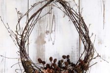 a fall twig wreath with lots of pinecones of various sizes is a gorgeous idea to rock for outdoors