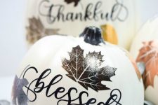 a faux pumpkin with calligraphy and bright and shiny lead stencils is a fantastic fall decoration