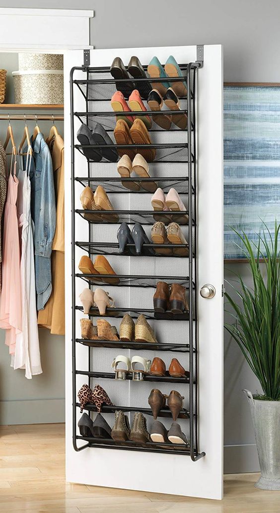 a forged shoe shelf attached to a clsoet door is a smart way to store a lot of shoes without using any floor space