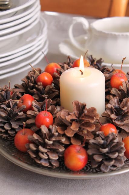 a great and easy fall centerpiece of a chic plate with pinecones, cherries and a pillar candle is fresh and non-typical