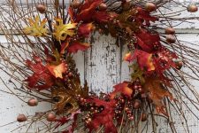 a lush twig fall wreath with bright faux leaves, acorns and berries will brign much color to the porch
