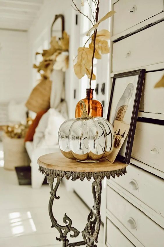 a mercury glass faux pumpkin is a stylish and shiny decoration you may create for the fall, it's chic and vintage-inspired