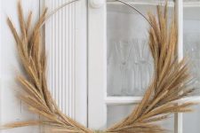a metal wreath form with wheat makes a nice wreath for the front door and looks chic